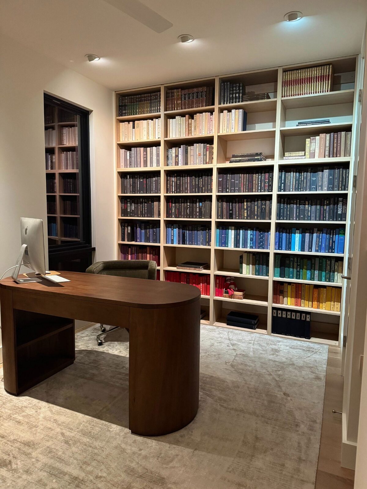 Built-in home library bookshelves with office desk