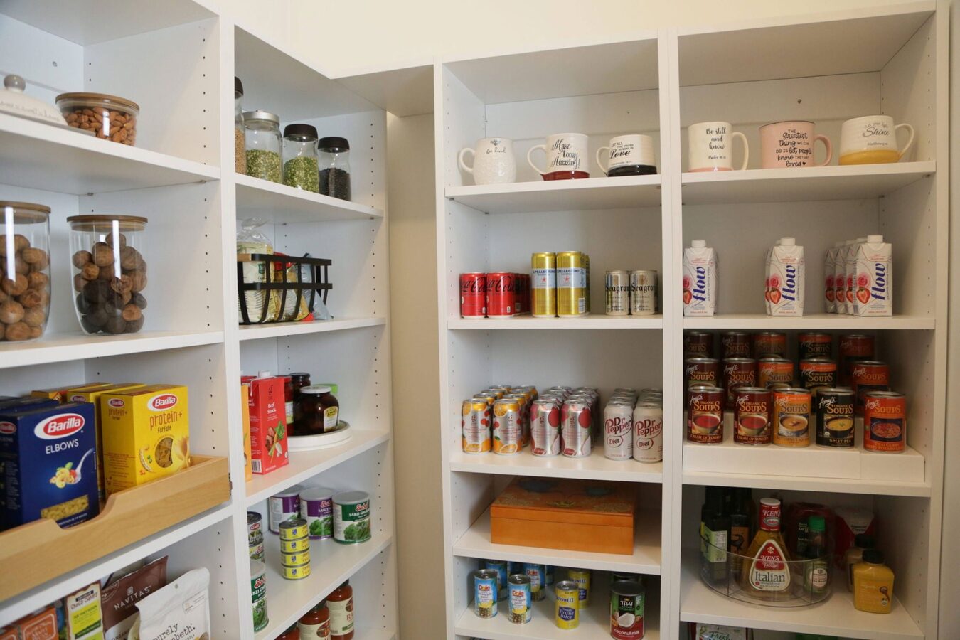 Custom white pantry shelving fully stocked