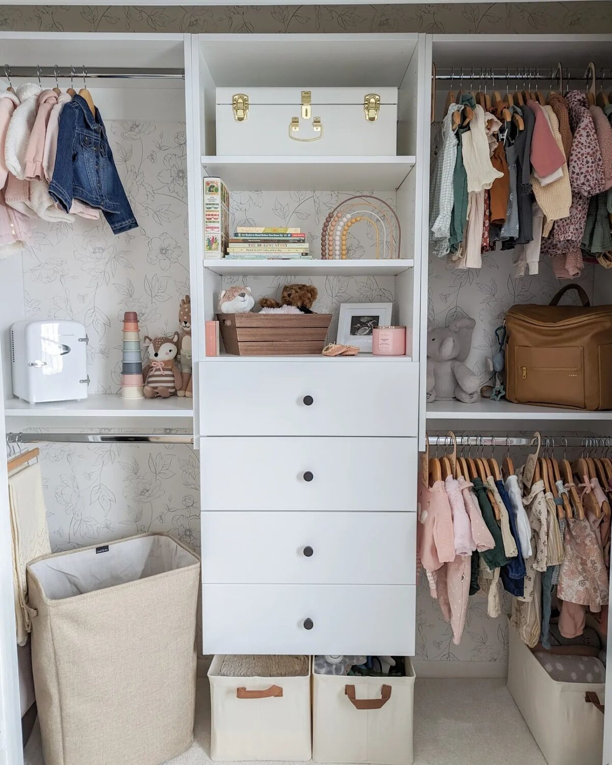 Organized nursery closet with drawers and shelves